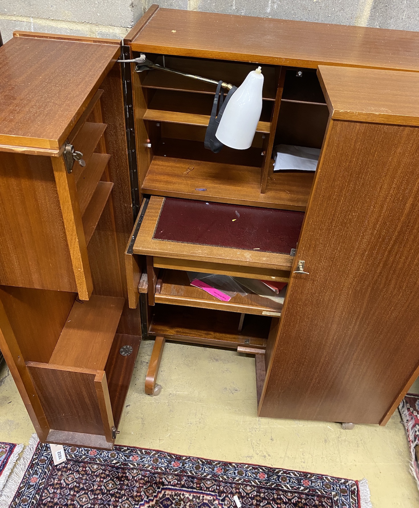 A mid century Newcraft Ltd. teak 'magic box' home office, width 84cm, depth 53cm, height 117cm
